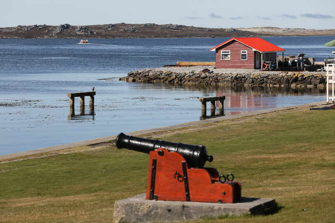 red and white house near body of water during daytime