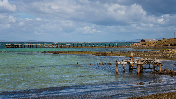 a man standing on a dock in the water